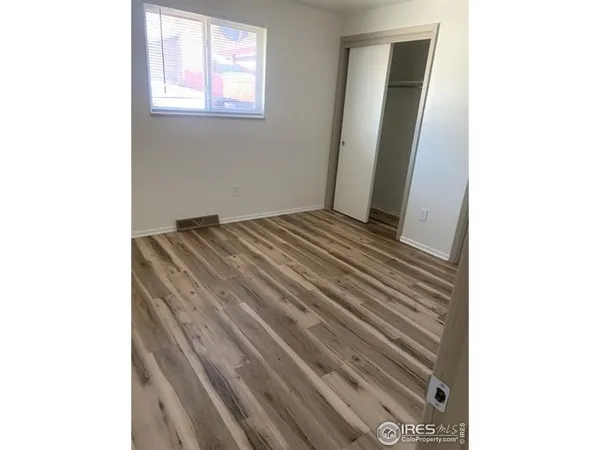 a kitchen with a sink cabinets and a window