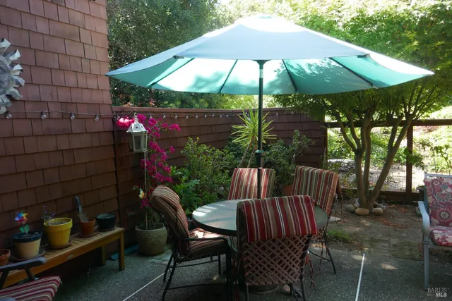 a view of a patio with furniture and backyard