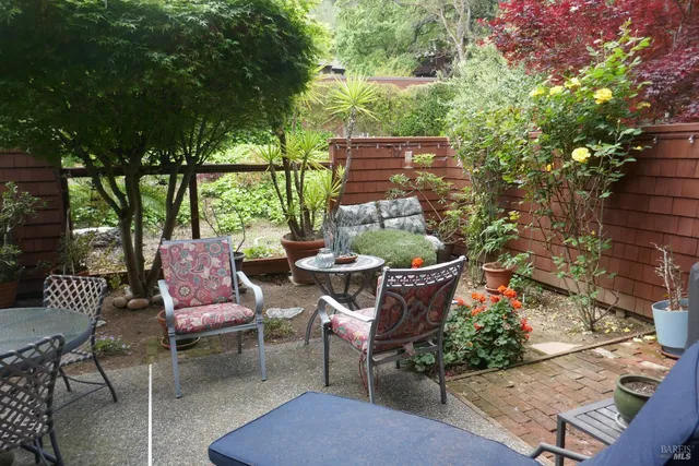 an outdoor sitting area with furniture and wooden floor