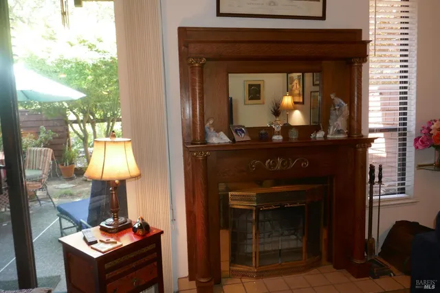 a living room with a fireplace and a chandelier