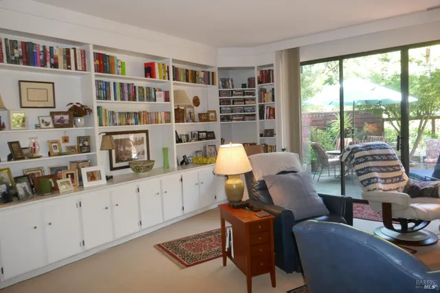 a living room with furniture cabinets and a book shelf
