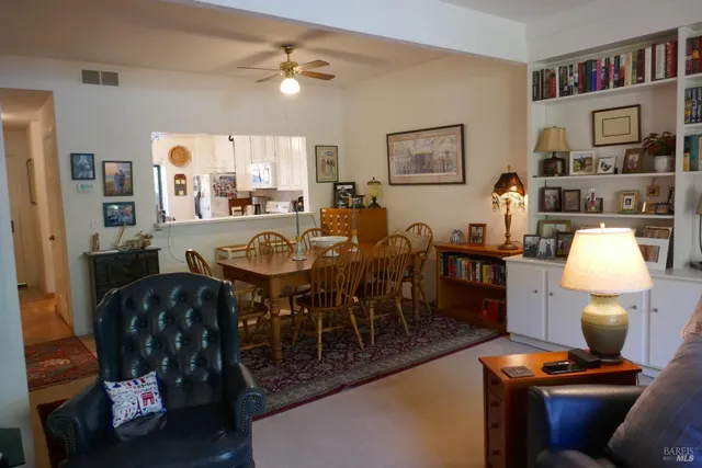 a view of a dining room with furniture and a rug