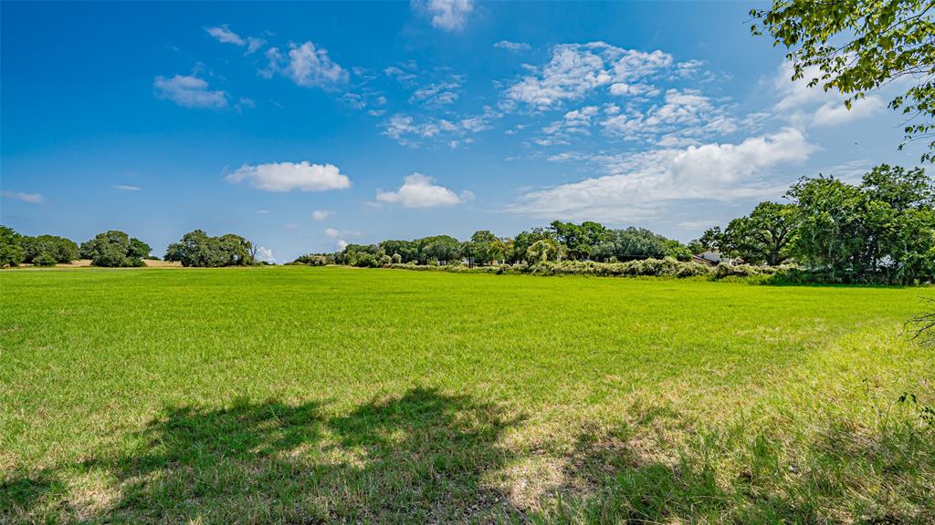 13345 Briar Road Azle, TX 76020 - Photo 12 of 26 View of grassy yard featuring a rural view and view of wooded area