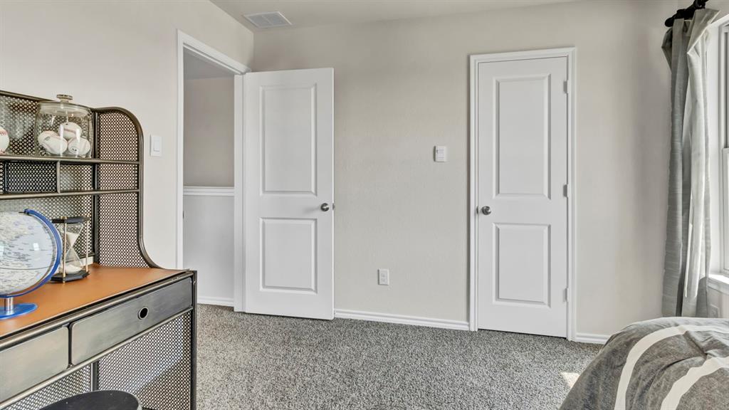 124 Pheasant Run Road Terrell, TX 75160 - Photo 15 of 35 Neutral wall paint and textured carpeting
