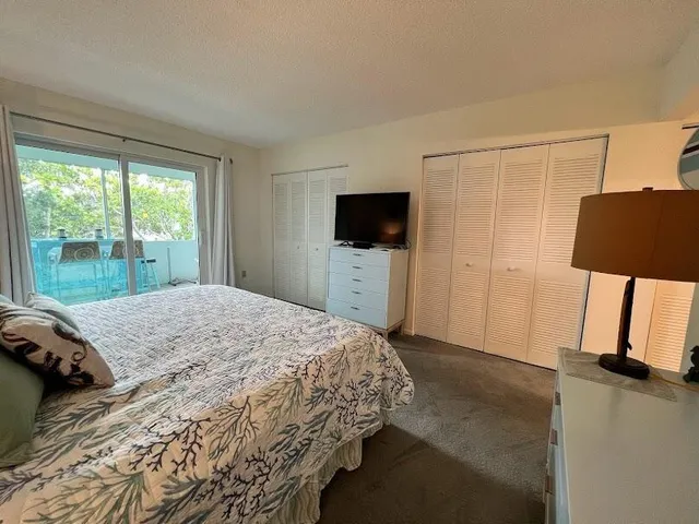 a bathroom with a granite countertop toilet sink and mirror