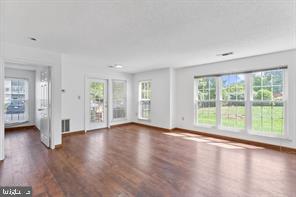 20979 Timber Ridge Terrace, Unit 101 Ashburn, VA 20147 - Photo 9 of 16 a view of an empty room with wooden floor and a window