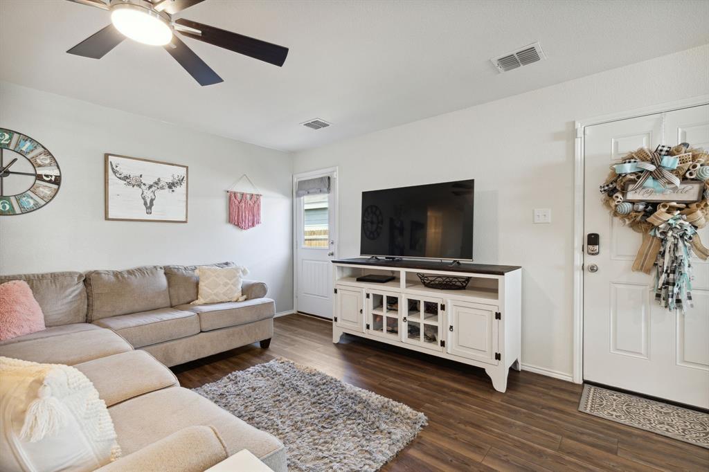 5513 Berea Street Forney, TX 75126 - Photo 8 of 29 In the living room you access the main entry, on the right, and the door to the backyard on the left.