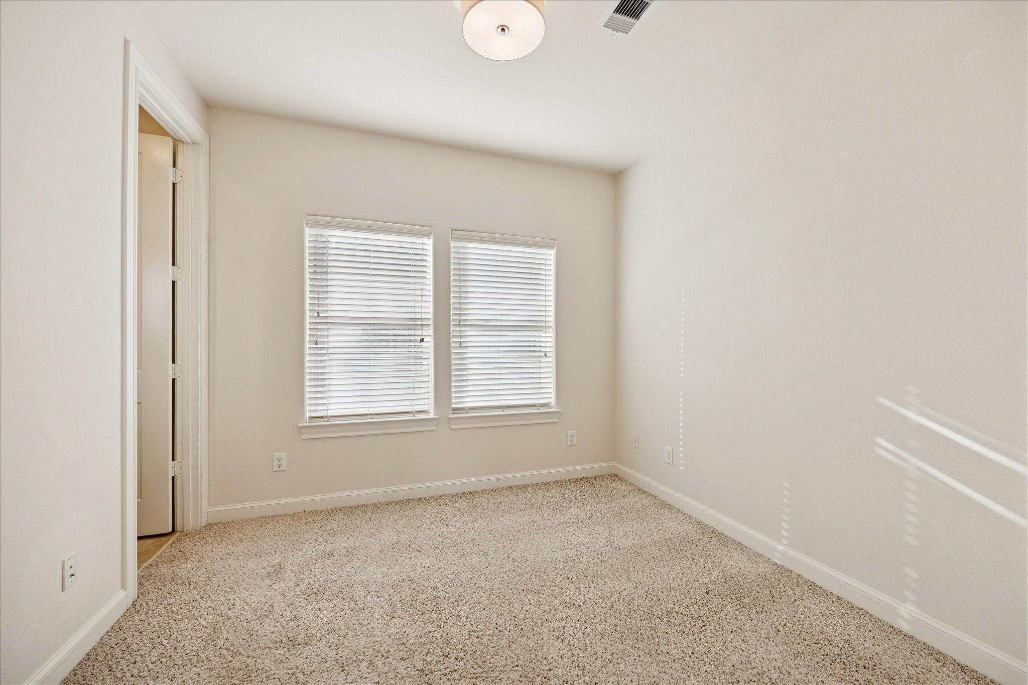 9682 Knight Road Houston, TX 77045 - Photo 12 of 19 BEDROOM - Additional secondary bedroom on the third floor with plush carpet and decorative pendant light.