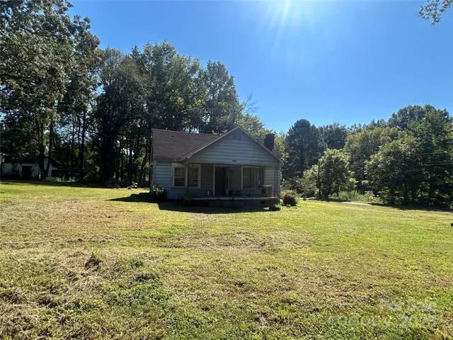 a view of a house with backyard porch and sitting area