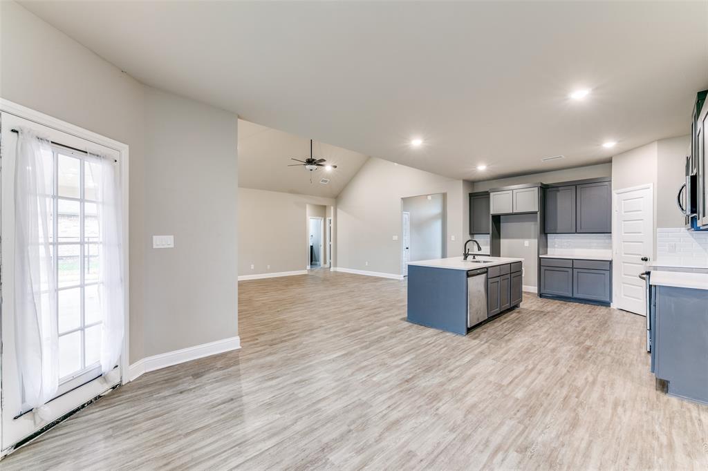 2844 Rodeo Drive Quinlan, TX 75474 - Photo 11 of 25 a large kitchen with stainless steel appliances kitchen island a large counter top and a wooden floors