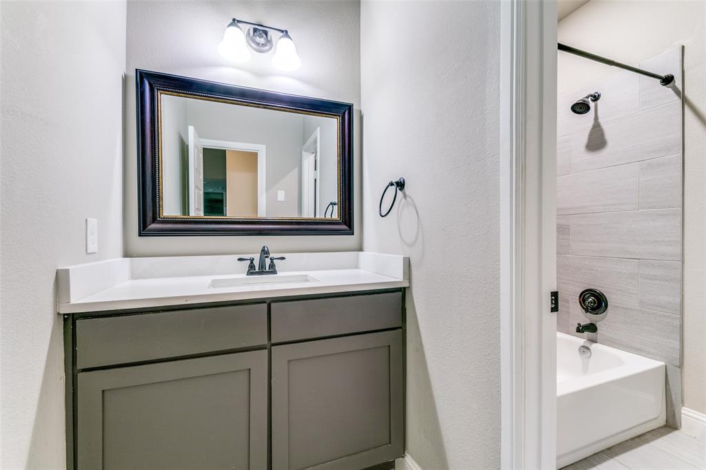 2844 Rodeo Drive Quinlan, TX 75474 - Photo 19 of 25 a bathroom with a sink and a mirror