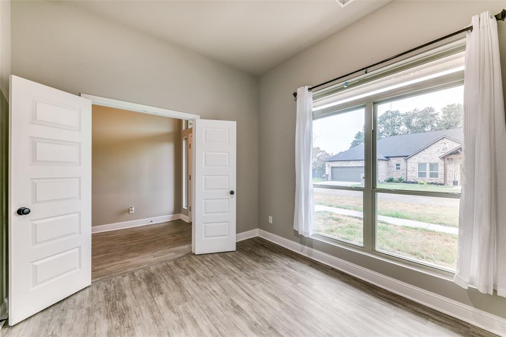 2844 Rodeo Drive Quinlan, TX 75474 - Photo 2 of 25 a view of wooden floor and windows in a room