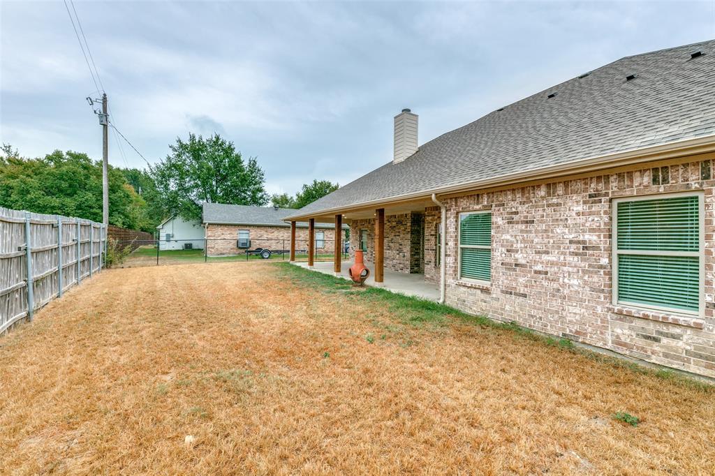 2844 Rodeo Drive Quinlan, TX 75474 - Photo 24 of 25 a view of a backyard with a garden and plants