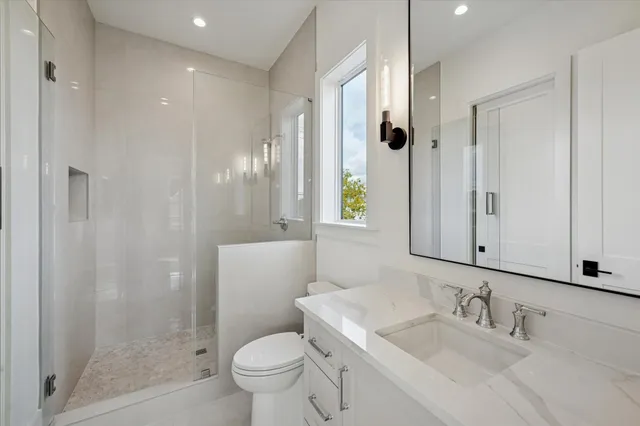 a bathroom with a sink toilet and shower