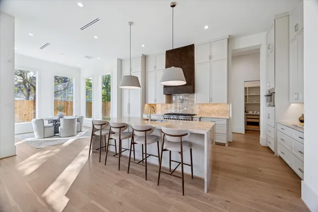a large kitchen with a table and chairs