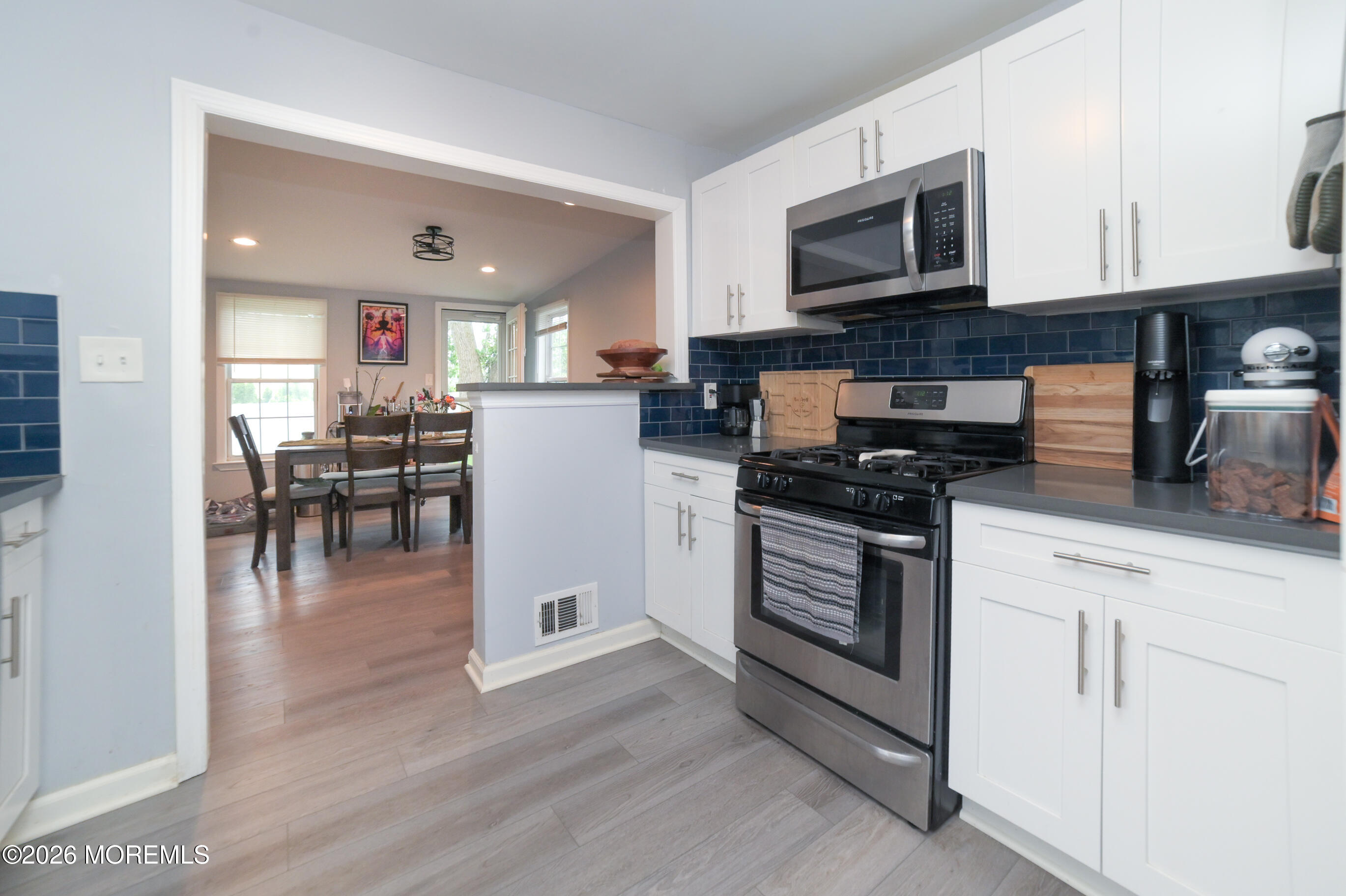 501 Gulden Street Keyport, NJ 07735 - Photo 6 of 14 a kitchen with granite countertop a stove top oven a sink a dining table and chairs