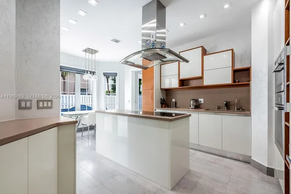 a kitchen with stainless steel appliances granite countertop a sink a stove and a wooden floors