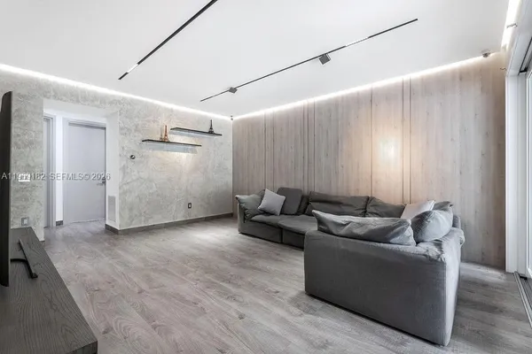 a living room with furniture and wooden floor