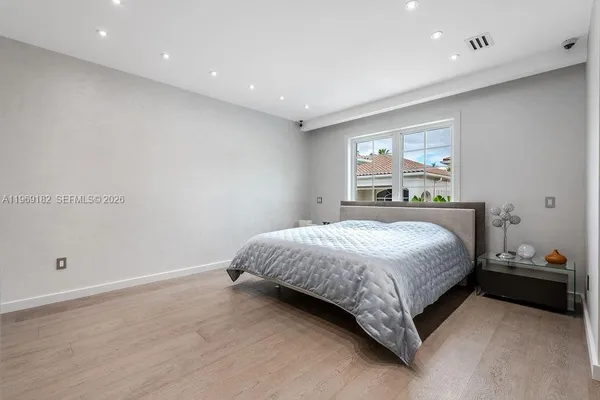 a bedroom with a bed and a night stand