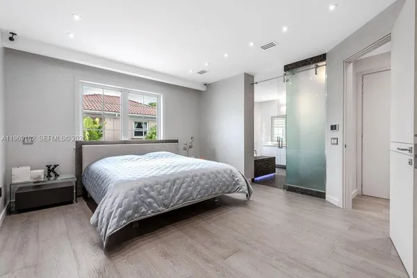 a bedroom with a bed and a window