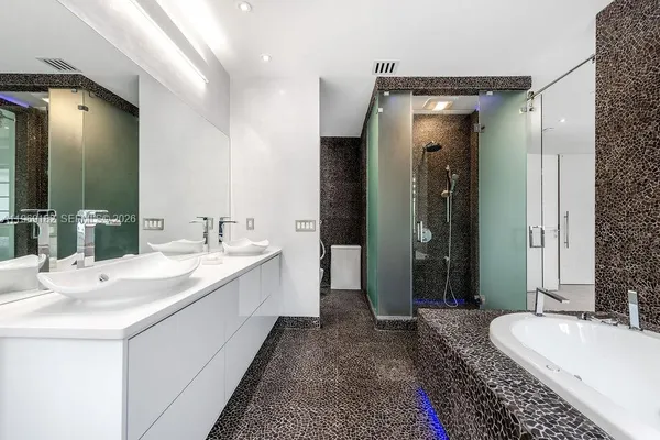 a spacious bathroom with a double vanity sink mirror and double