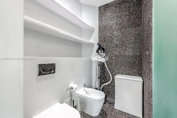 a white toilet sitting next to a shower curtain