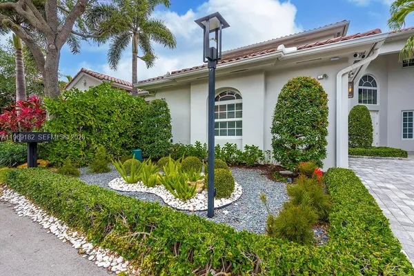 a front view of a house with garden