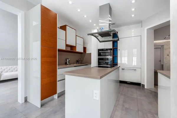 a kitchen with stainless steel appliances kitchen island granite countertop a sink and cabinets