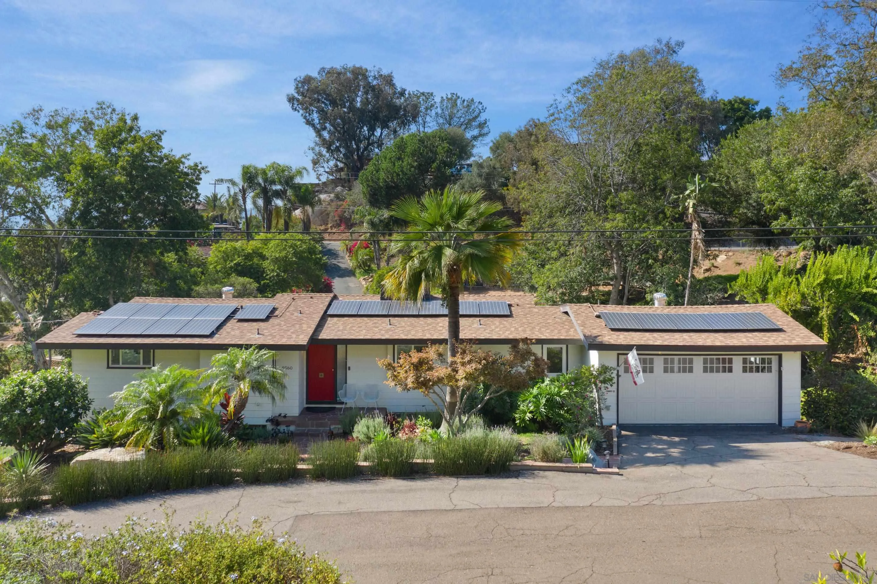 a front view of a house with a yard and a garage
