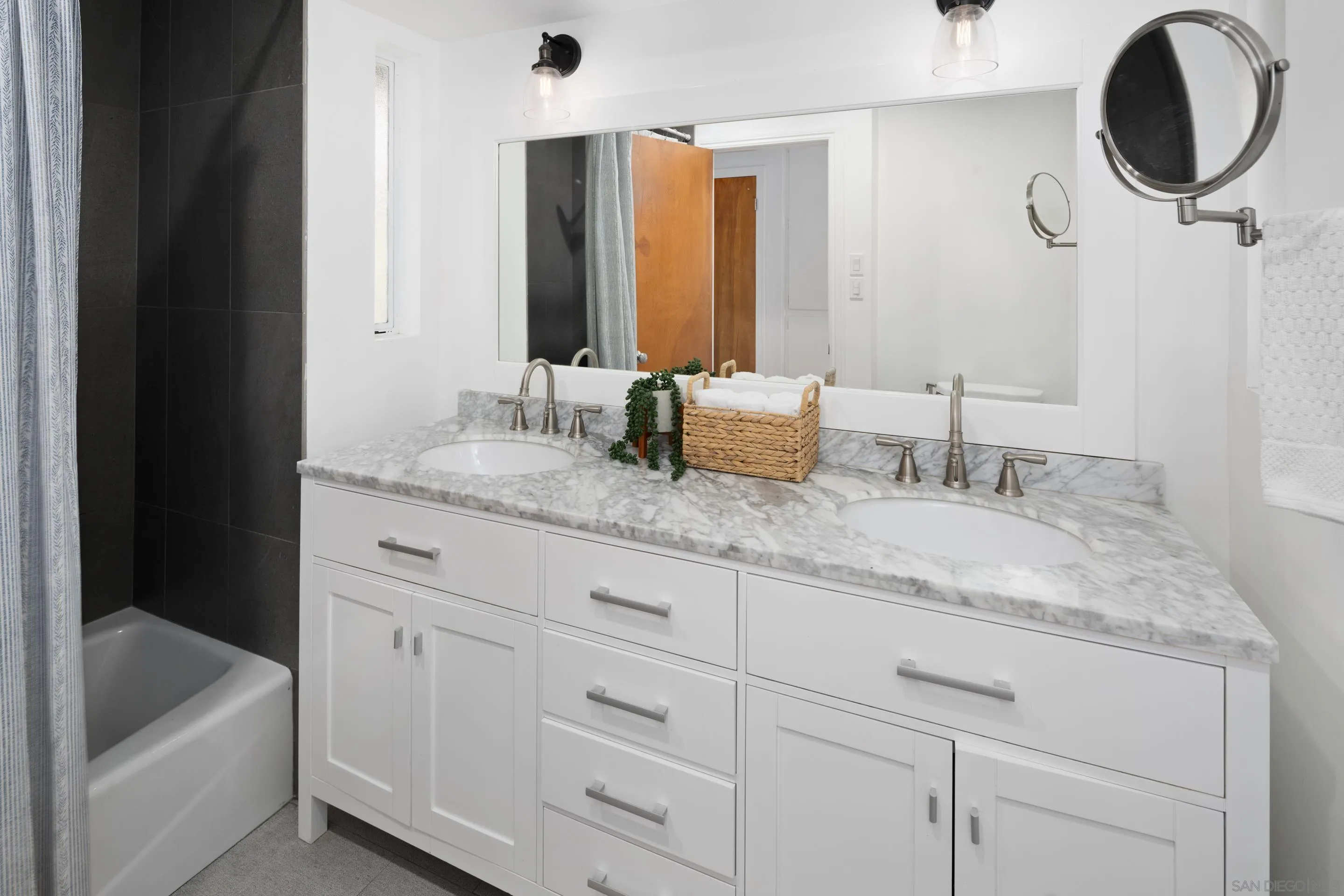 9560 Starlight Lane La Mesa, CA 91941 - Photo 9 of 18 a bathroom with a granite countertop sink and a mirror