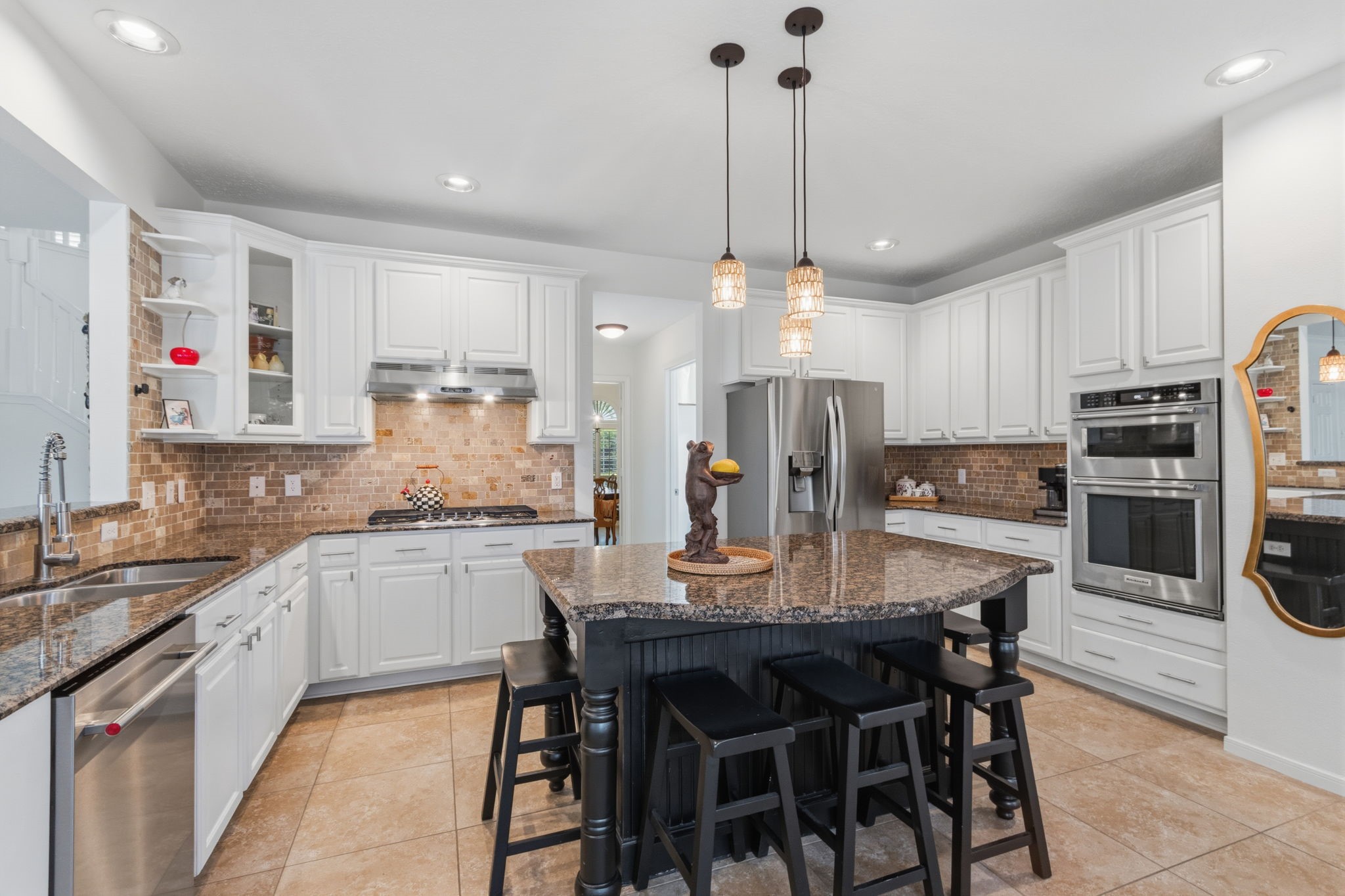 8419 Marchelle Lane Spring, TX 77379 - Photo 7 of 42 a kitchen with stainless steel appliances kitchen island granite countertop a table chairs microwave and cabinets