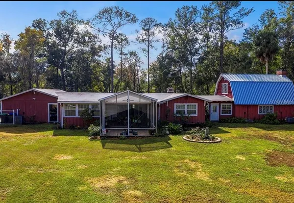 a view of a house with swimming pool and a yard