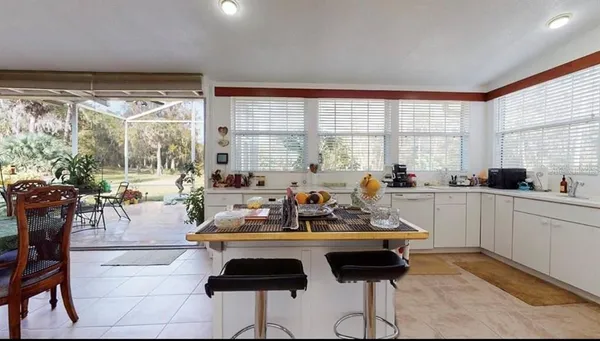 a kitchen with a refrigerator and white cabinets