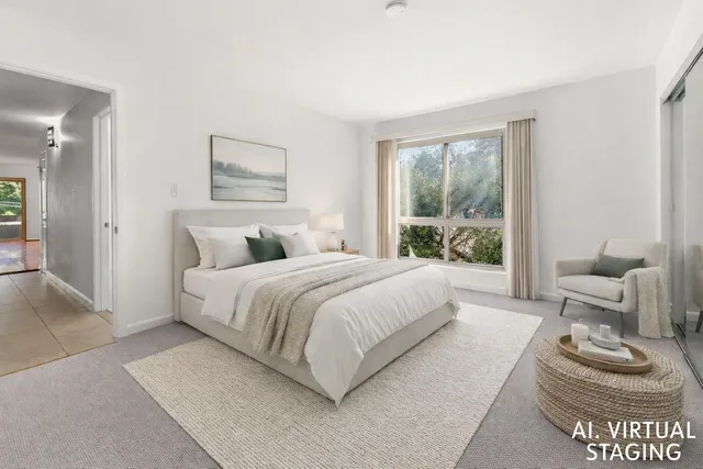 a bedroom with a bed and a couch