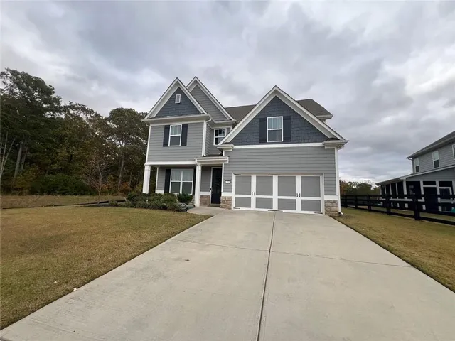 a front view of a house with a yard and garage