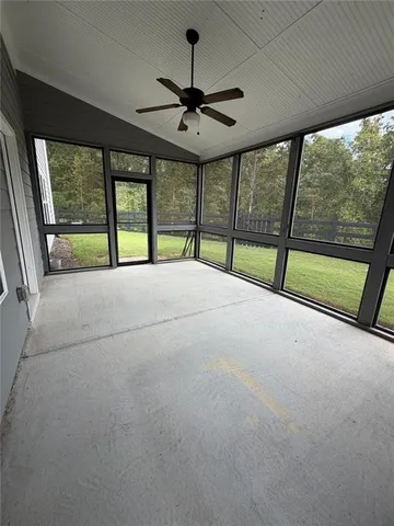 a view of empty room with fireplace and fan