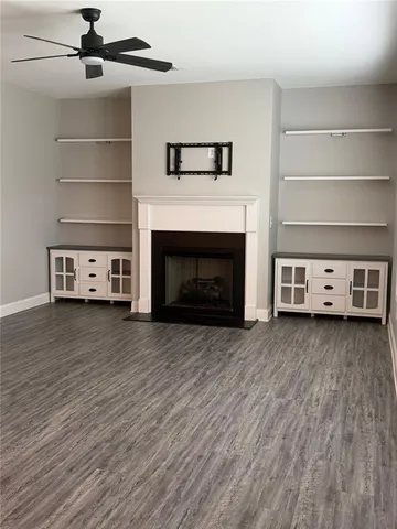 a view of a livingroom with furniture fire place and wooden floor