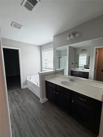 a bathroom with a sink a vanity and a mirror