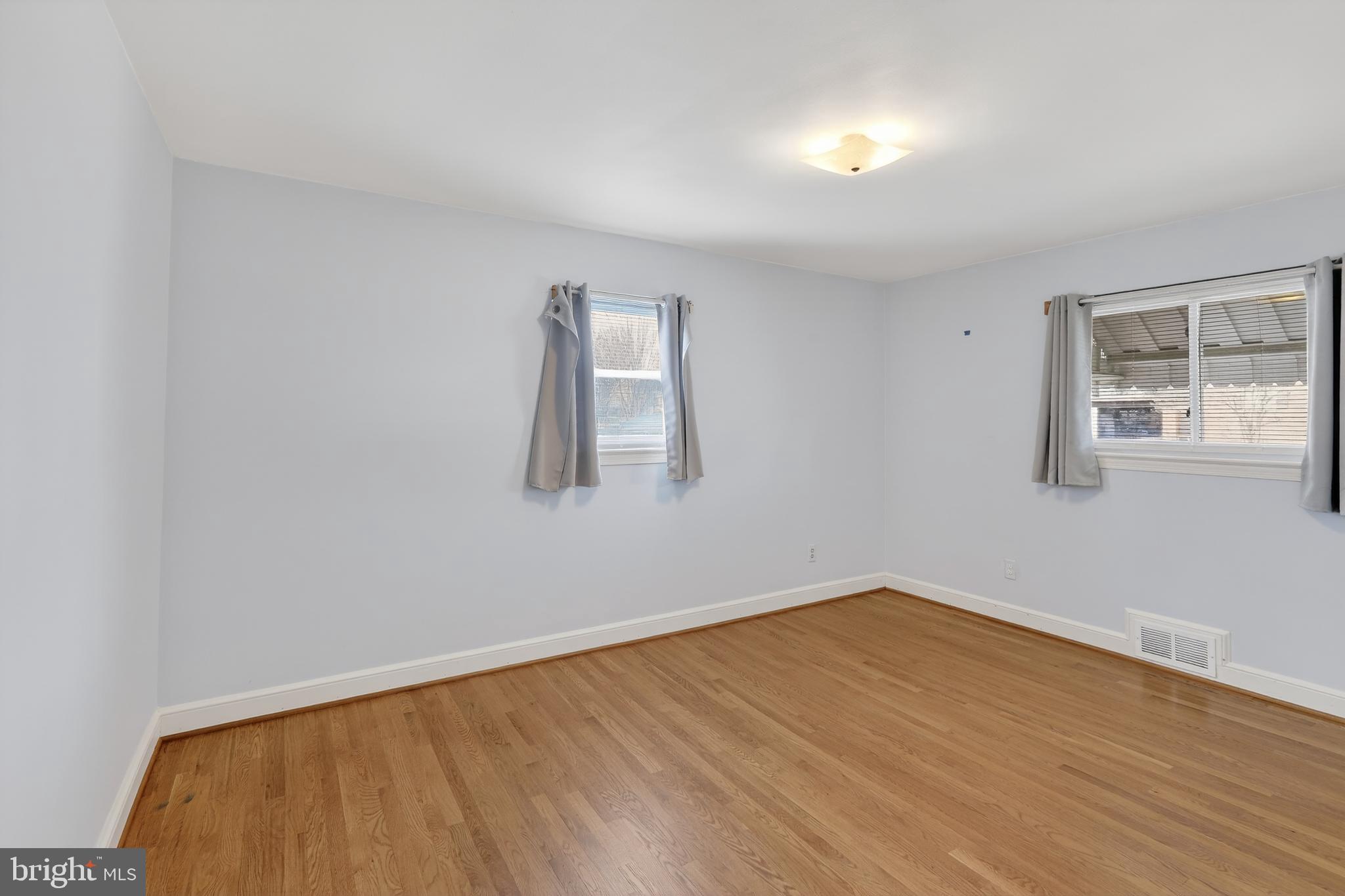 6001 Dinwiddie Street Springfield, VA 22150 - Photo 17 of 42 a view of an empty room with wooden floor and a window