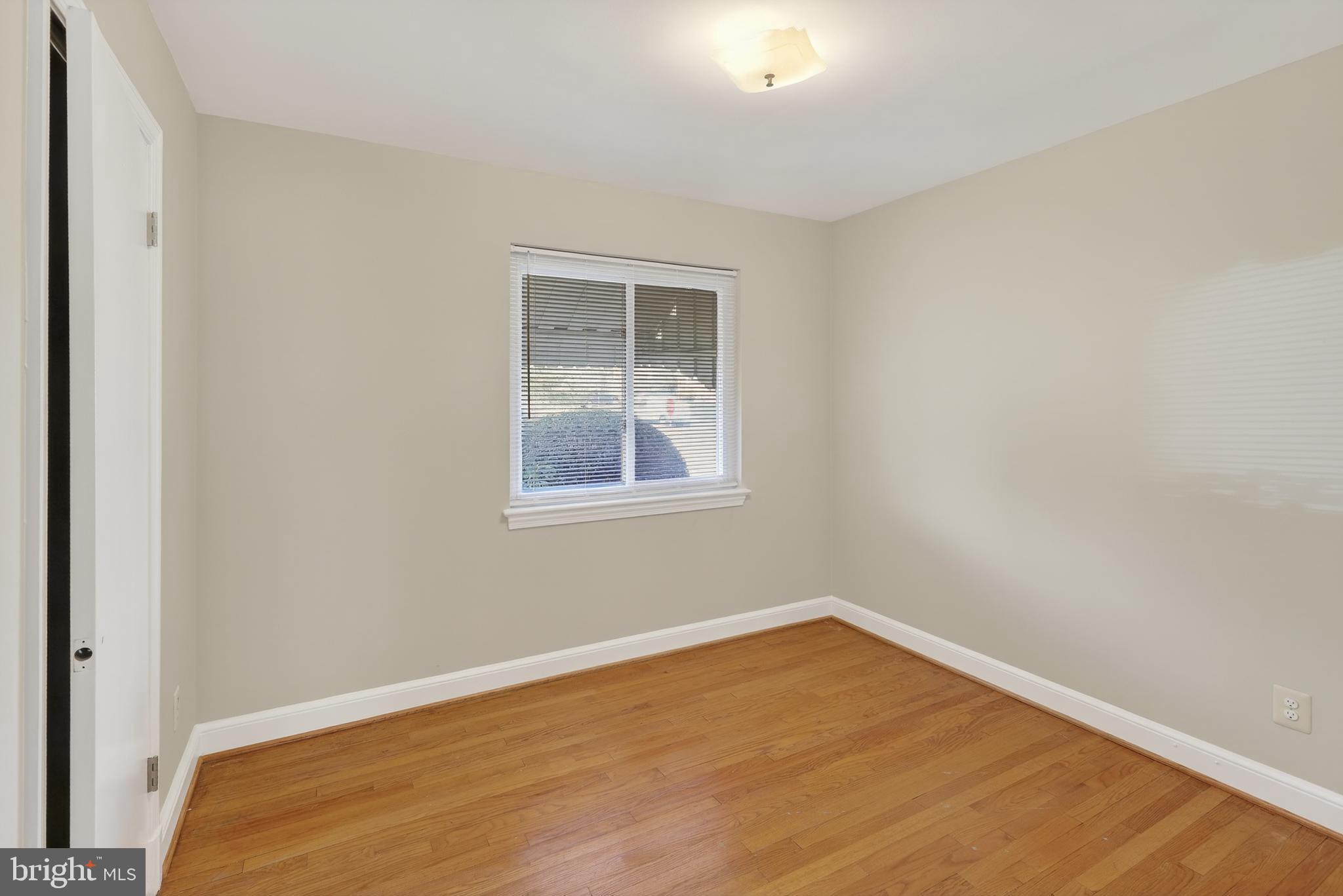 6001 Dinwiddie Street Springfield, VA 22150 - Photo 19 of 42 a view of an empty room with wooden floor and a window