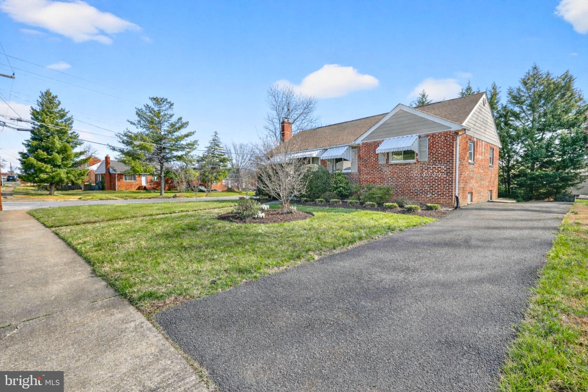 6001 Dinwiddie Street Springfield, VA 22150 - Photo 2 of 42 a front view of a house with a yard