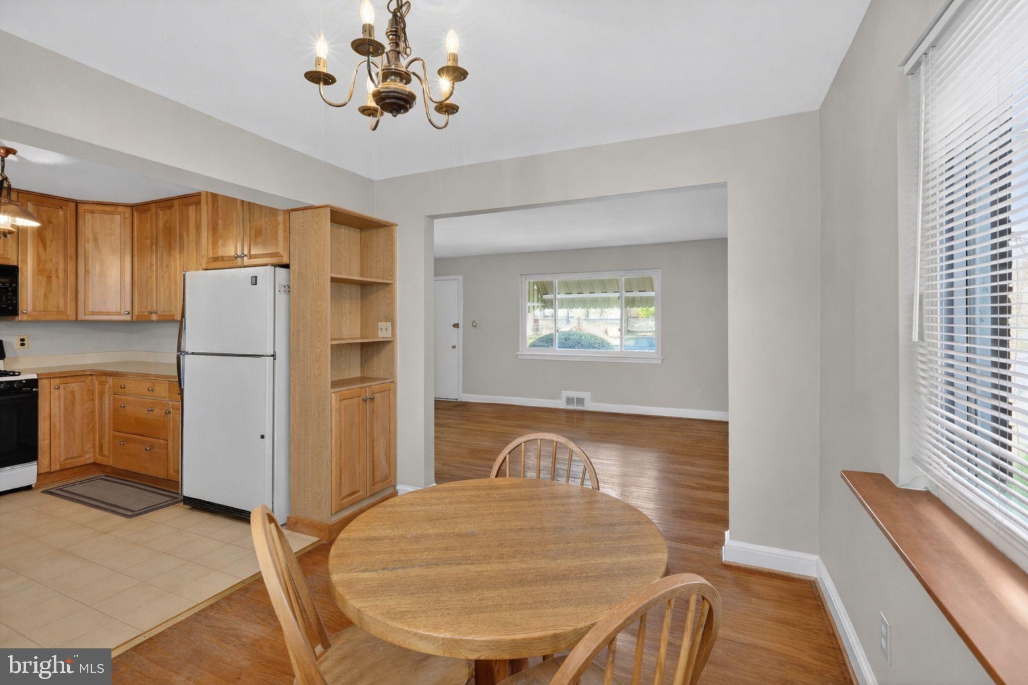 6001 Dinwiddie Street Springfield, VA 22150 - Photo 5 of 42 a kitchen with a refrigerator and a chandelier