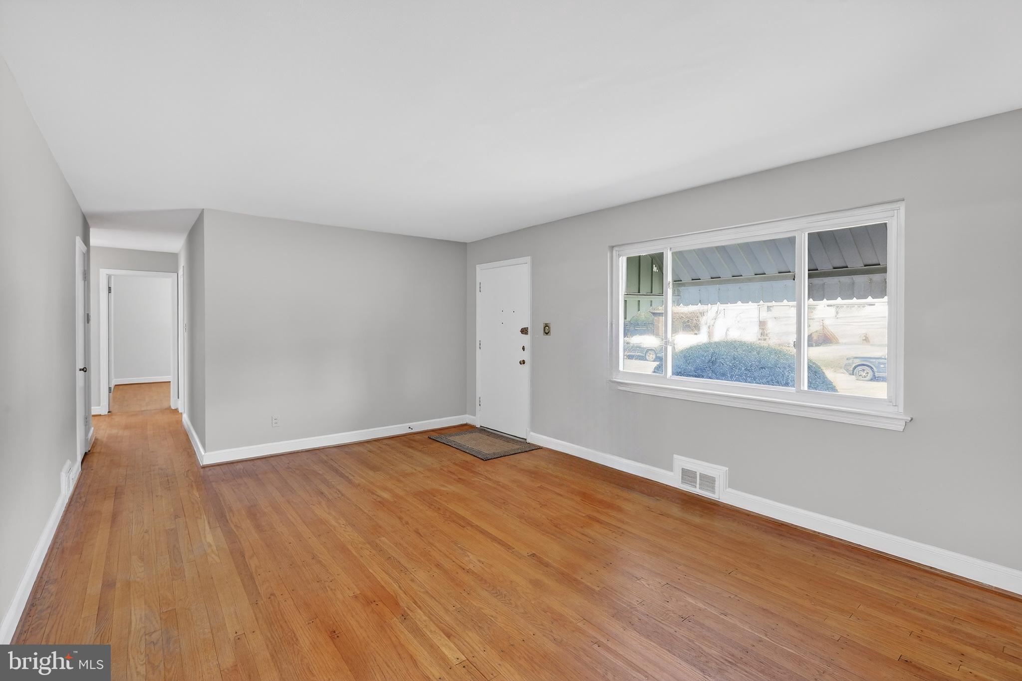 6001 Dinwiddie Street Springfield, VA 22150 - Photo 8 of 42 a view of an empty room with wooden floor and a window