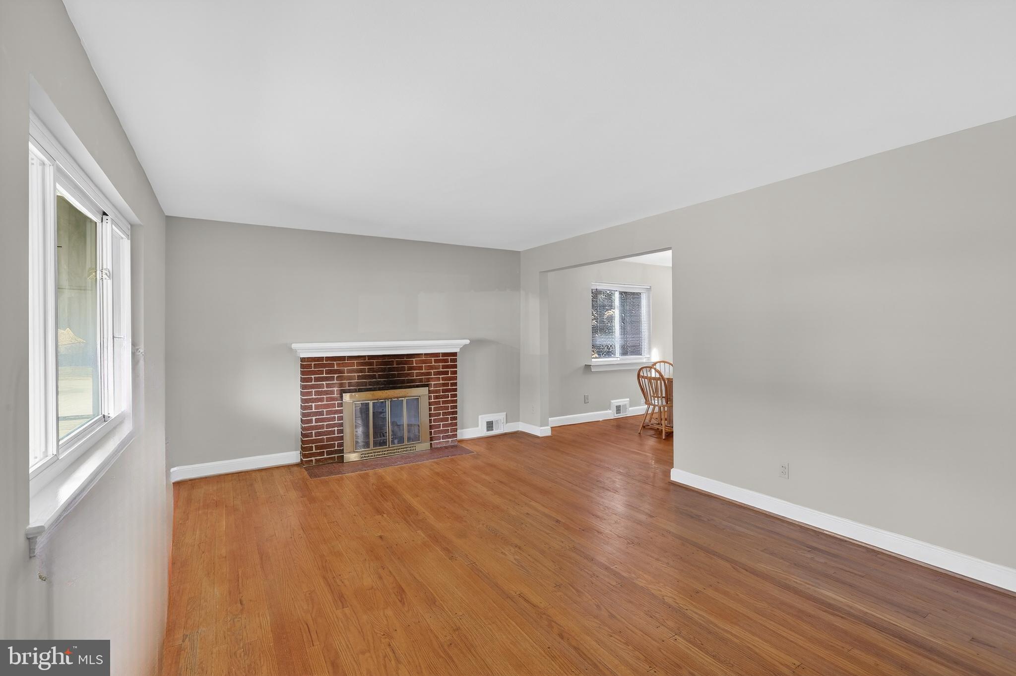 6001 Dinwiddie Street Springfield, VA 22150 - Photo 10 of 42 an empty room with wooden floor fireplace and windows