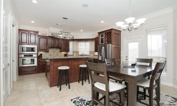 a view of a dining room with furniture and chandelier