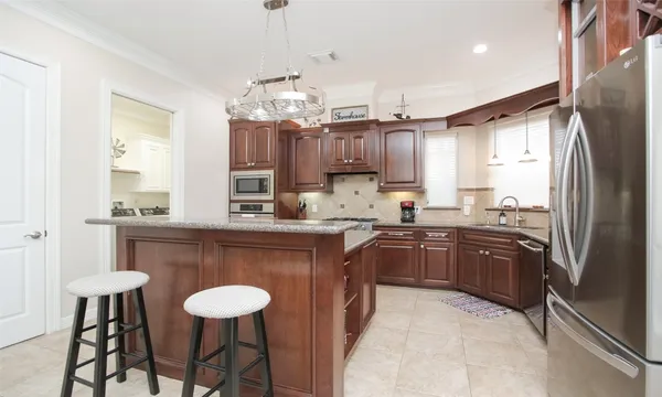 a view of a dining room kitchen counter top space and stainless steel appliances