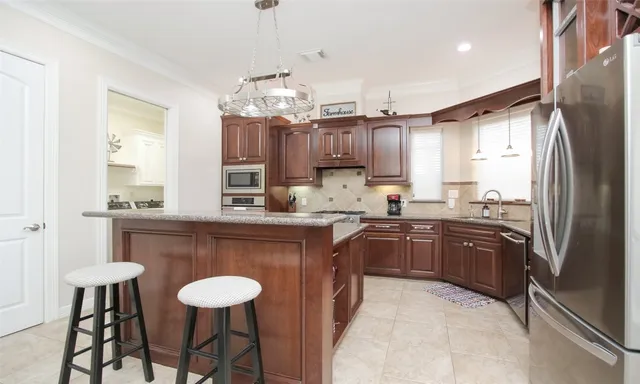 a view of a dining room kitchen counter top space and stainless steel appliances