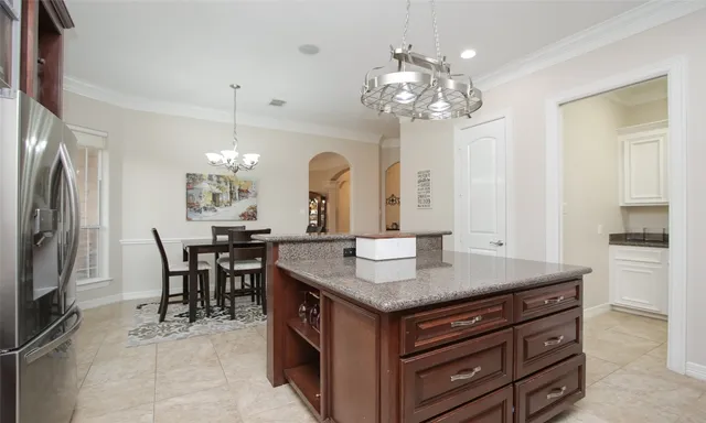 a kitchen with granite countertop white cabinets and white appliances