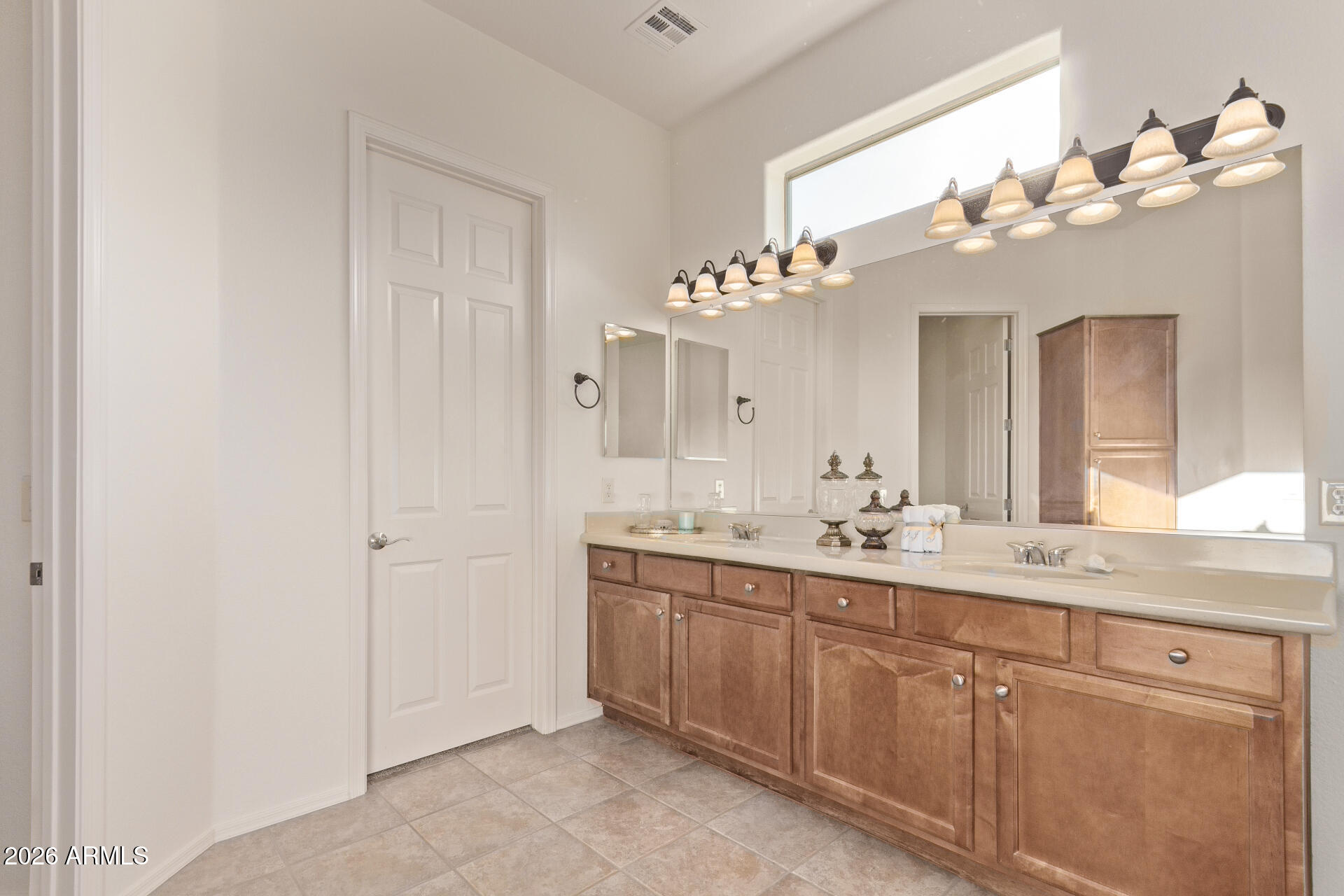4120 East Jude Lane Gilbert, AZ 85298 - Photo 19 of 61 a bathroom with a double vanity and a mirror