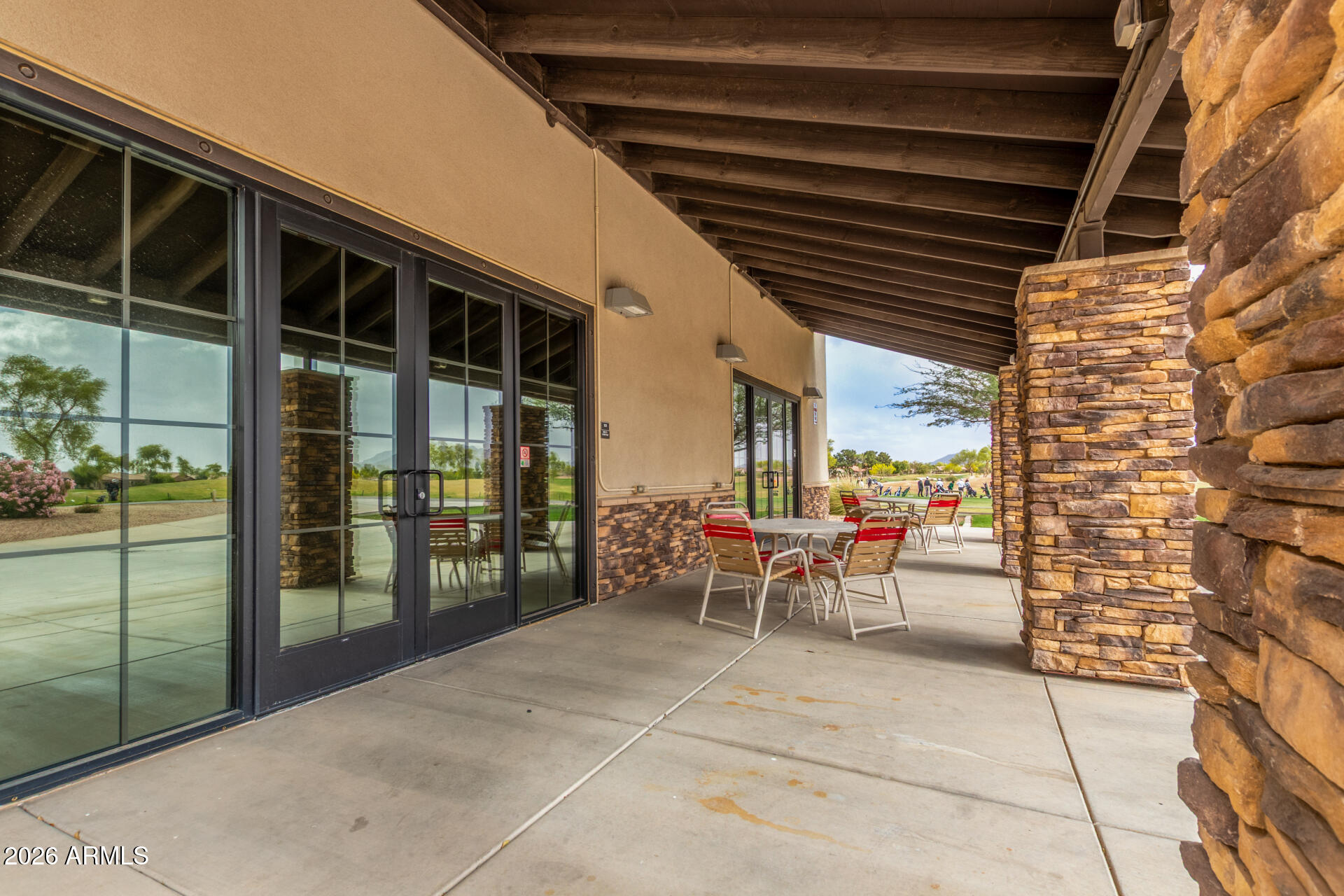 4120 East Jude Lane Gilbert, AZ 85298 - Photo 57 of 61 a view of a porch with chairs and floor to ceiling window